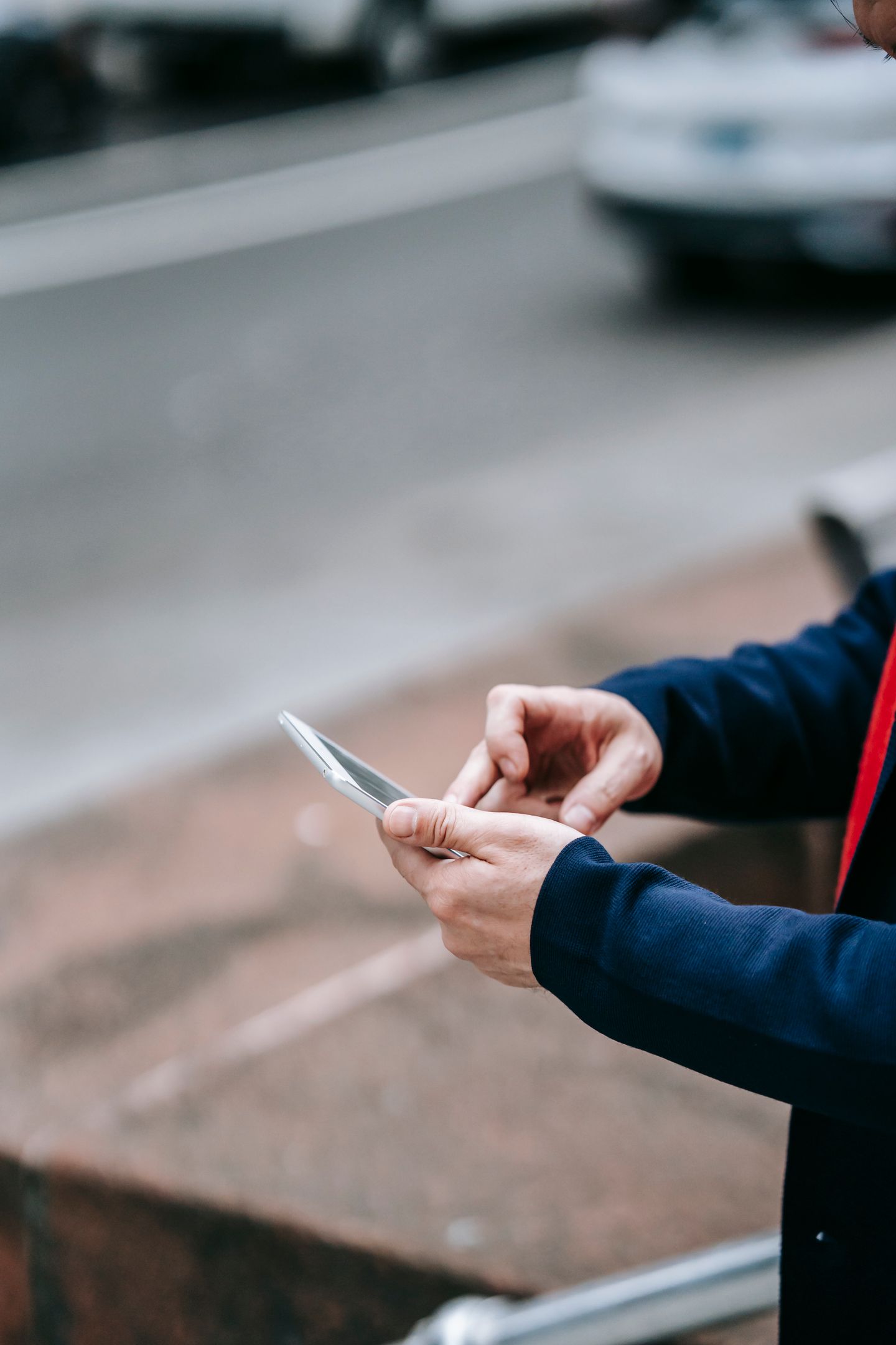 A professional using a smartphone outdoors.